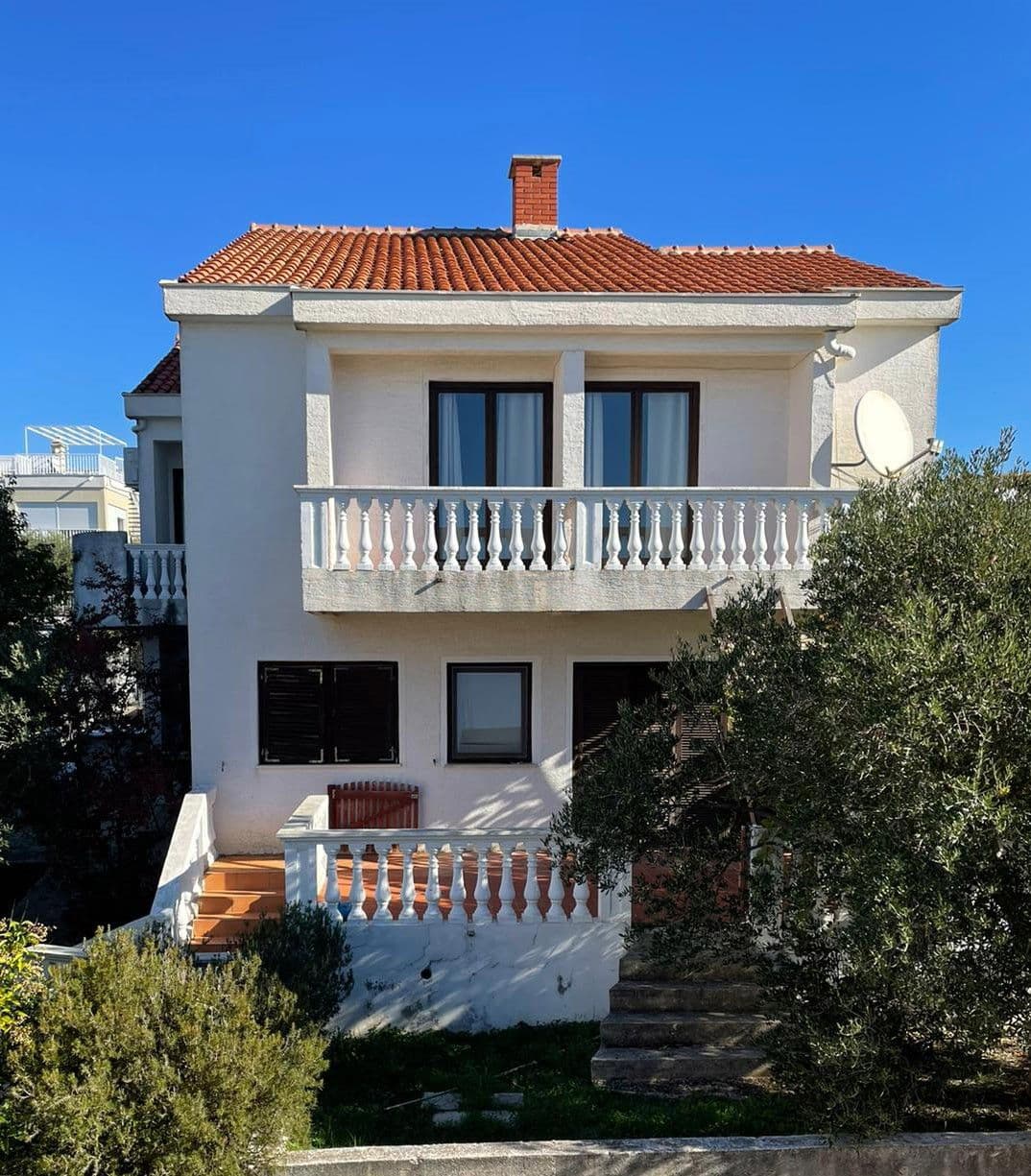 Villa Dorade: a white house with a red roof and balconies